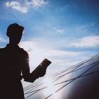Man-worker-firld-by-solar-panels