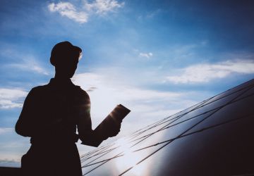 Man-worker-firld-by-solar-panels